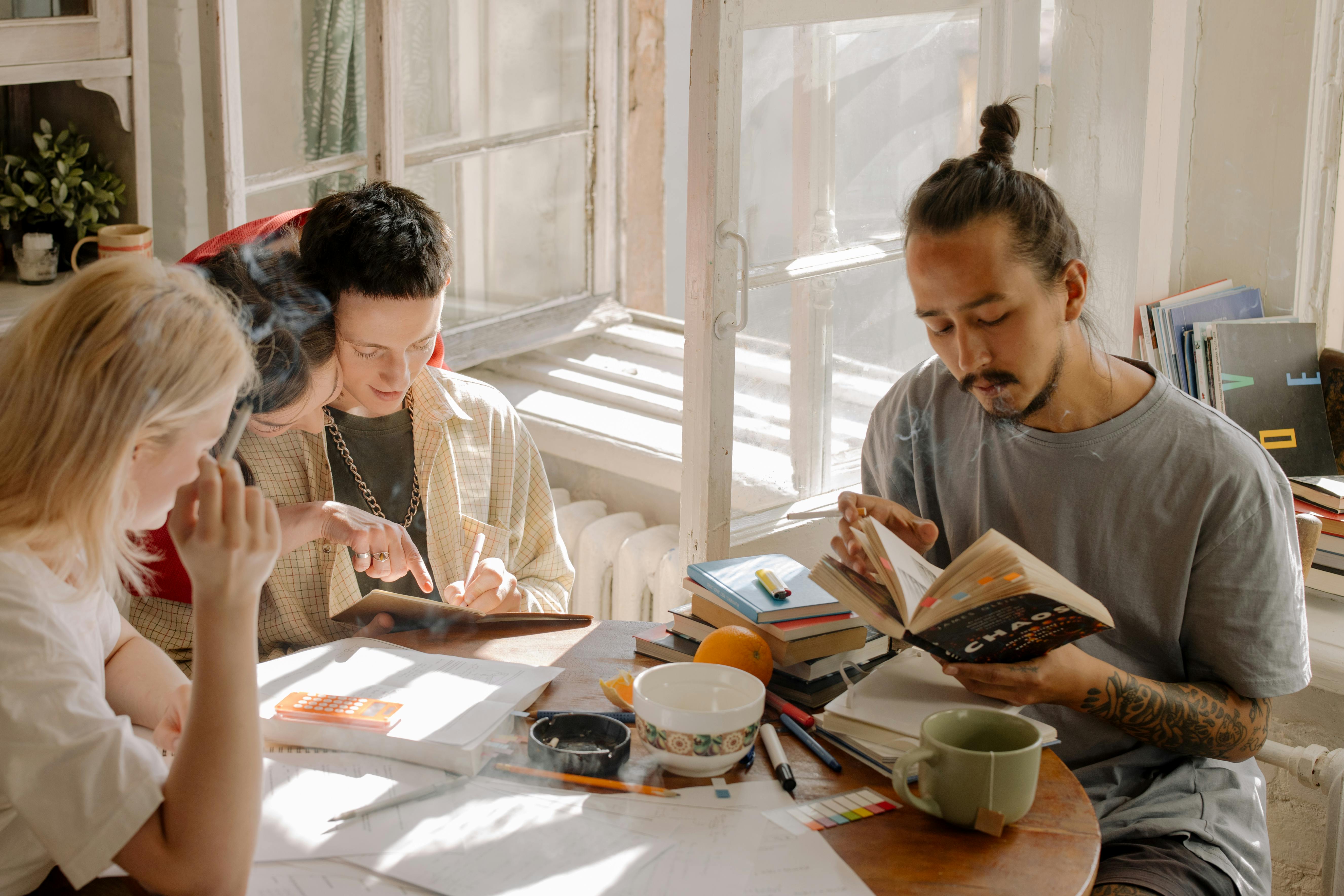 group of people reading at a table